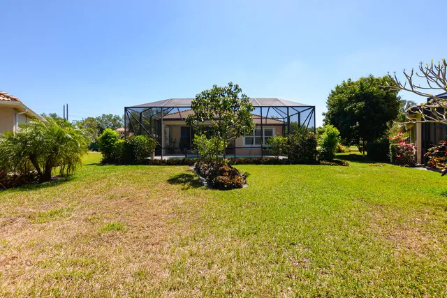 a living room with furniture a rug and white walls