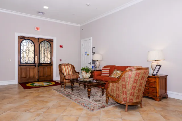 a living room with furniture a chandelier and a dining table