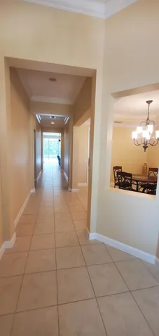 a view of a hallway with wooden floor and a cabinet