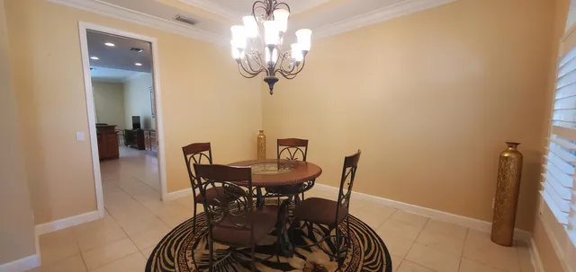 a view of a dining room with furniture and chandelier