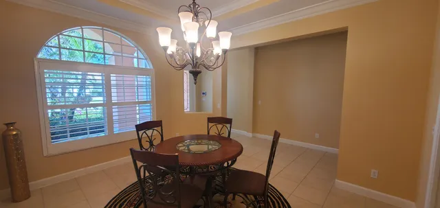 a view of a dining room with furniture and a chandelier