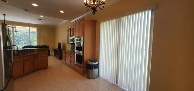 a kitchen with stainless steel appliances a refrigerator and a stove top oven