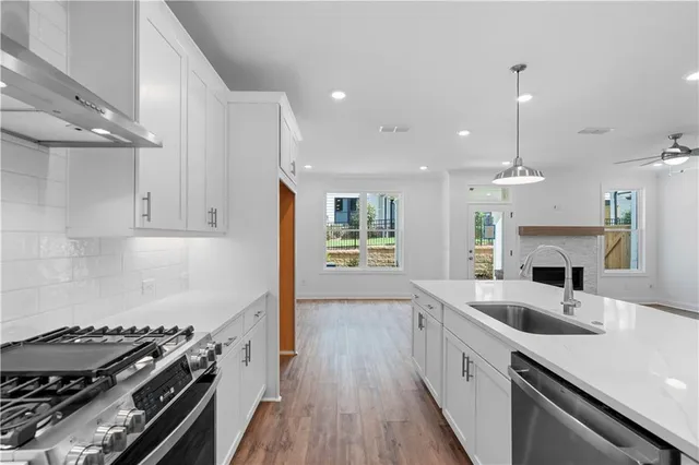 a kitchen with granite countertop a stove and a sink