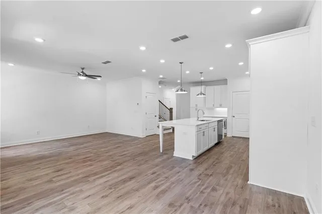 a view of kitchen with kitchen island and stainless steel appliances