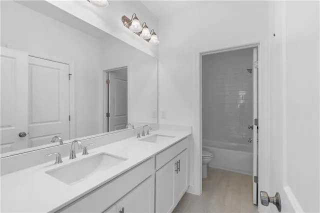 a bathroom with a double vanity sink mirror and double