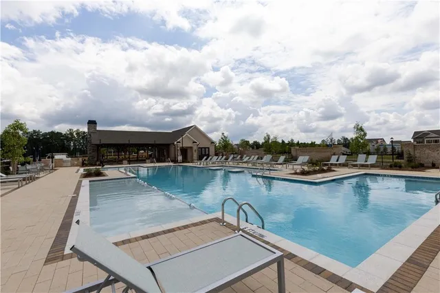 a view of swimming pool with outdoor seating