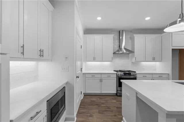 a kitchen with a stove sink and cabinets
