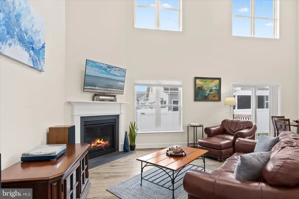 a kitchen with stainless steel appliances granite countertop a stove top oven a refrigerator a sink and dishwasher with wooden floor
