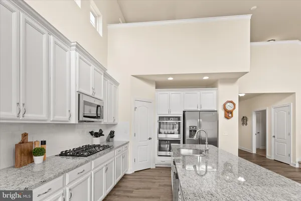 a living room with furniture kitchen view and a fireplace