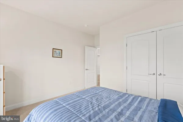 a view of a hallway to a livingroom with wooden floor and entryway