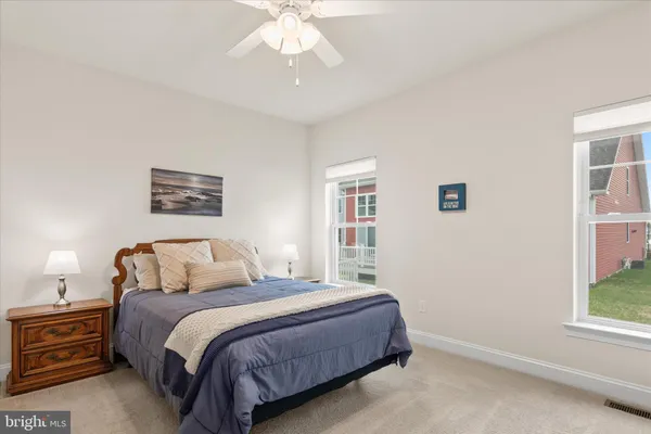 a living room with furniture a large window and a chandelier
