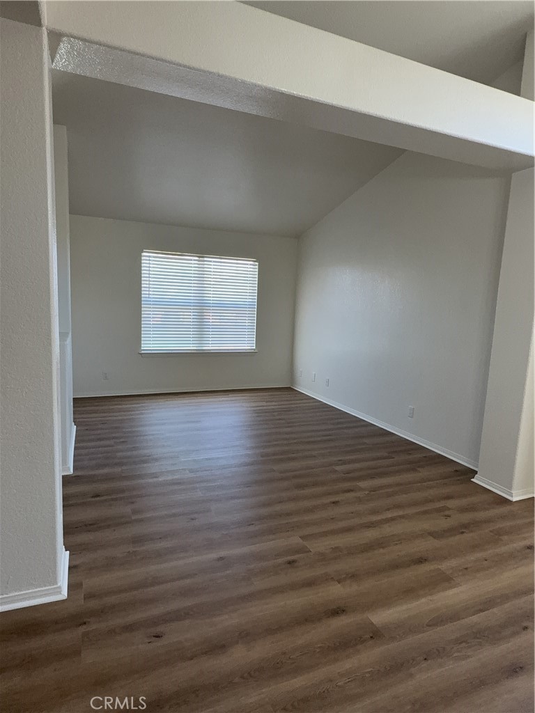 12590 Cobalt Road Victorville, CA 92392 - Photo 11 of 37 an empty room with wooden floor and windows