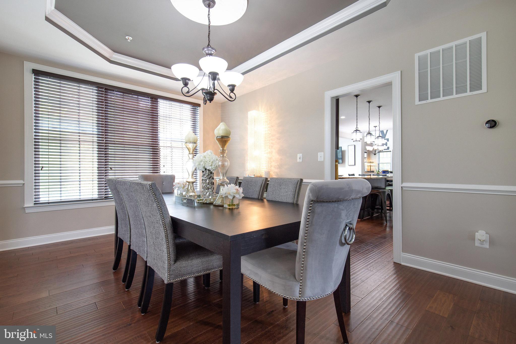 4201 Rolling Paddock Drive Upper Marlboro, MD 20772 - Photo 14 of 62 a view of a dining room with furniture window and wooden floor