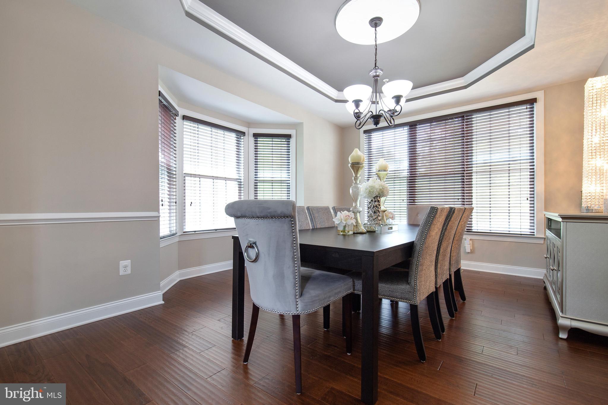 4201 Rolling Paddock Drive Upper Marlboro, MD 20772 - Photo 16 of 62 a view of a dining room with furniture window and wooden floor