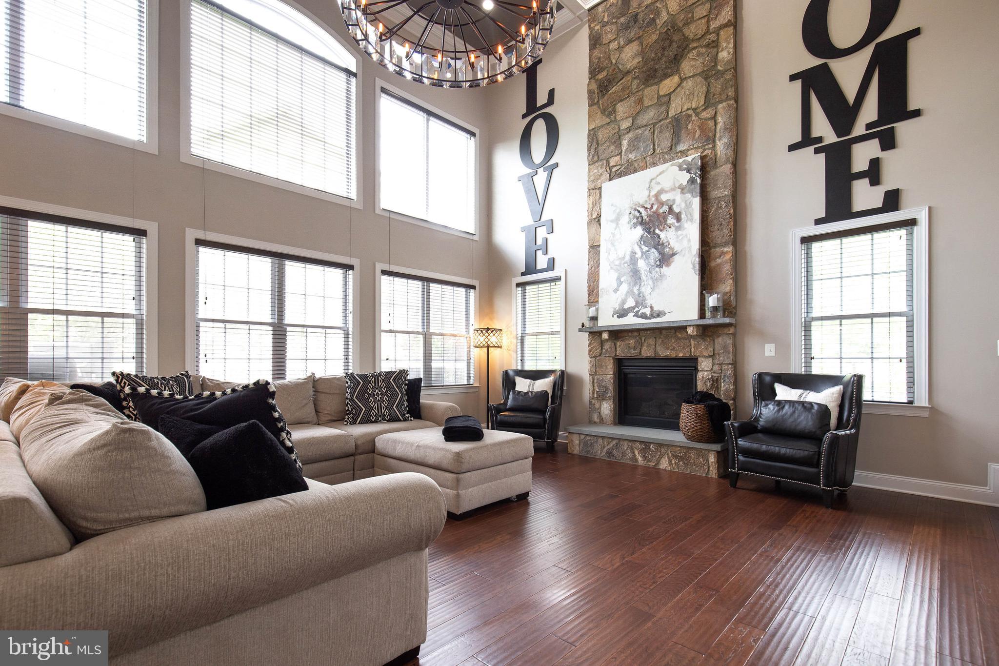 4201 Rolling Paddock Drive Upper Marlboro, MD 20772 - Photo 17 of 62 a living room with fireplace furniture and a large window