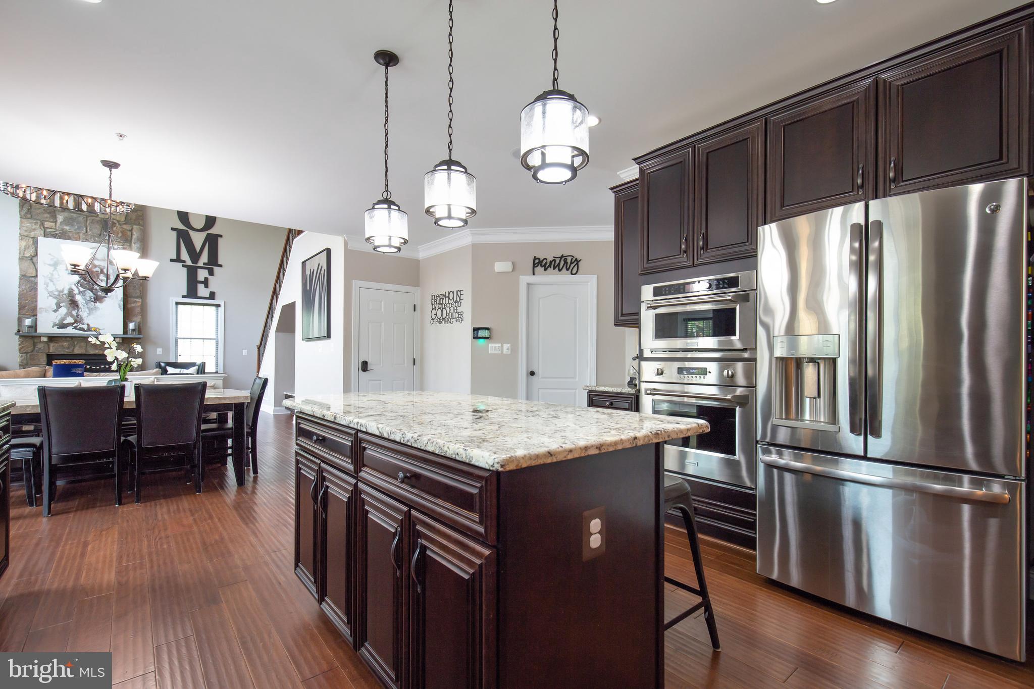 4201 Rolling Paddock Drive Upper Marlboro, MD 20772 - Photo 23 of 62 a kitchen with stainless steel appliances granite countertop a refrigerator a oven a stove and a wooden floors