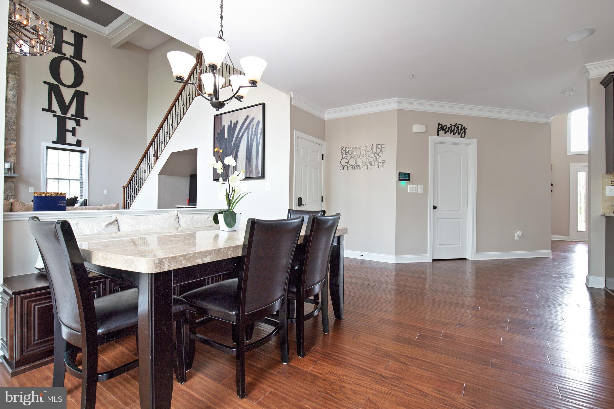 4201 Rolling Paddock Drive Upper Marlboro, MD 20772 - Photo 24 of 62 a view of a dining room with furniture and wooden floor