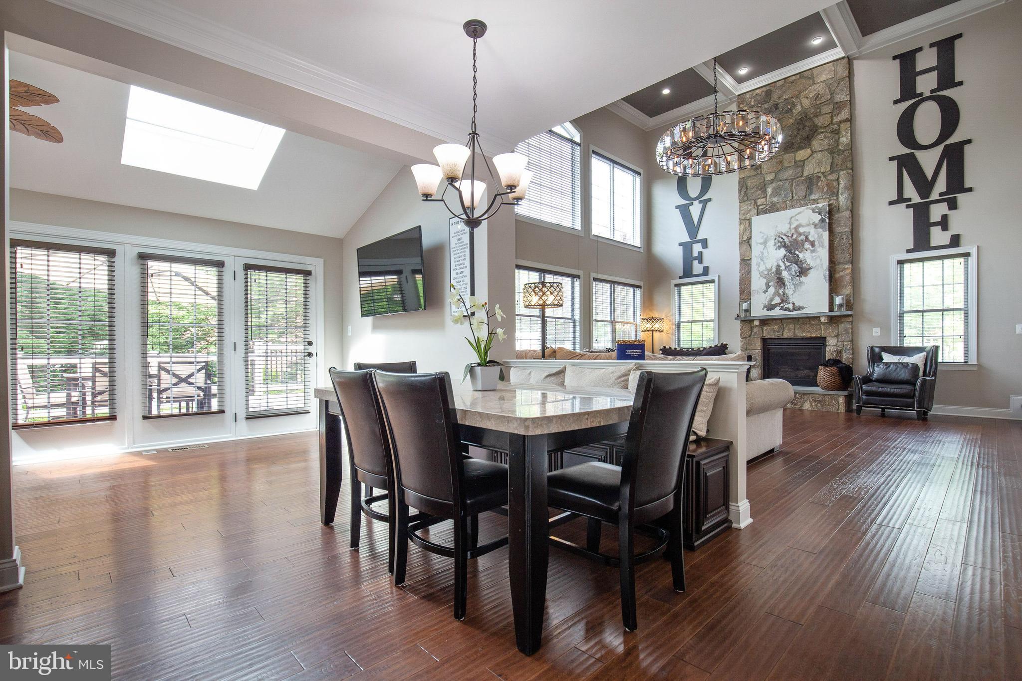 4201 Rolling Paddock Drive Upper Marlboro, MD 20772 - Photo 25 of 62 a view of a dining room with furniture wooden floor and chandelier