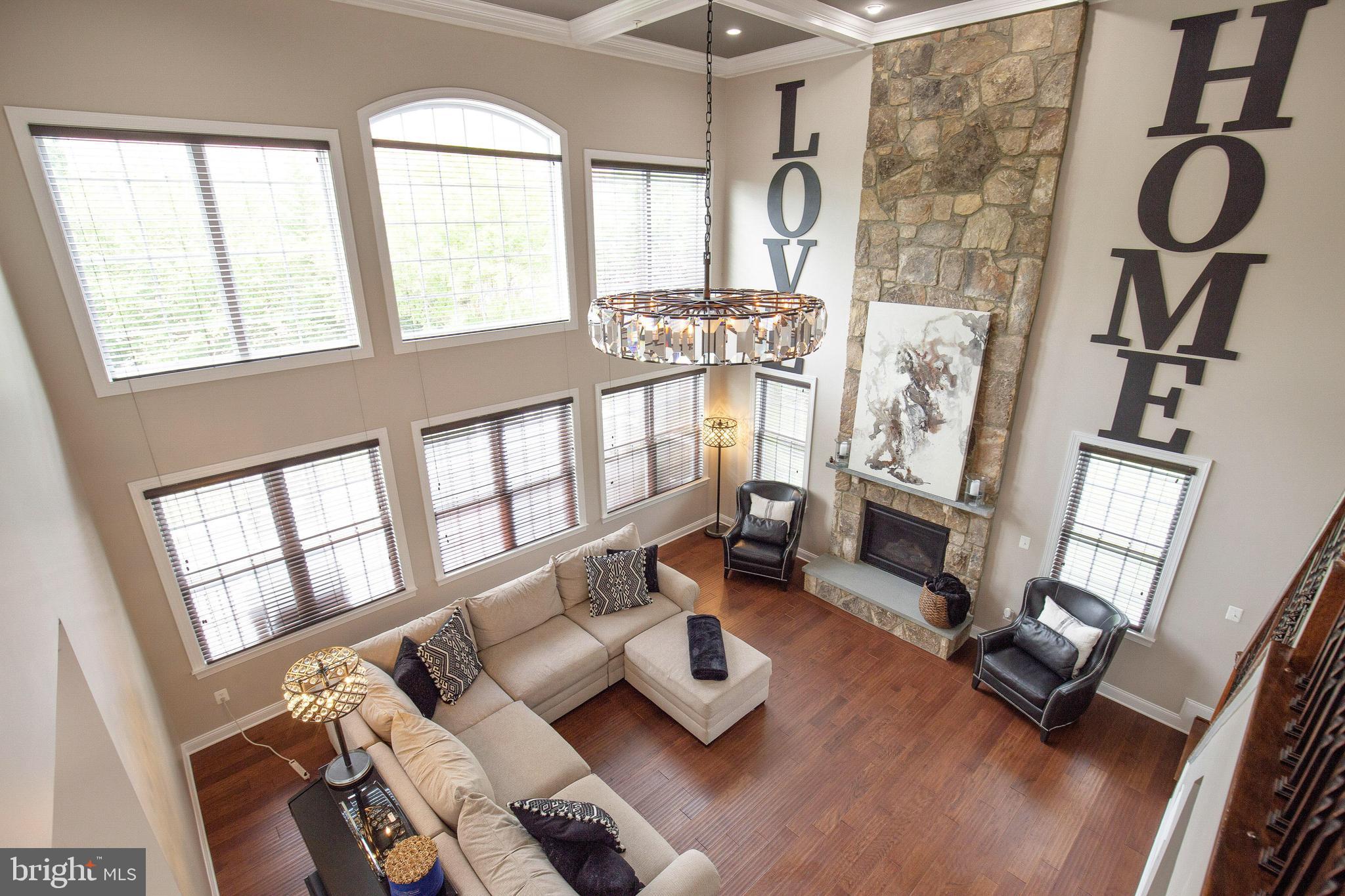 4201 Rolling Paddock Drive Upper Marlboro, MD 20772 - Photo 30 of 62 a living room with furniture and floor to ceiling windows