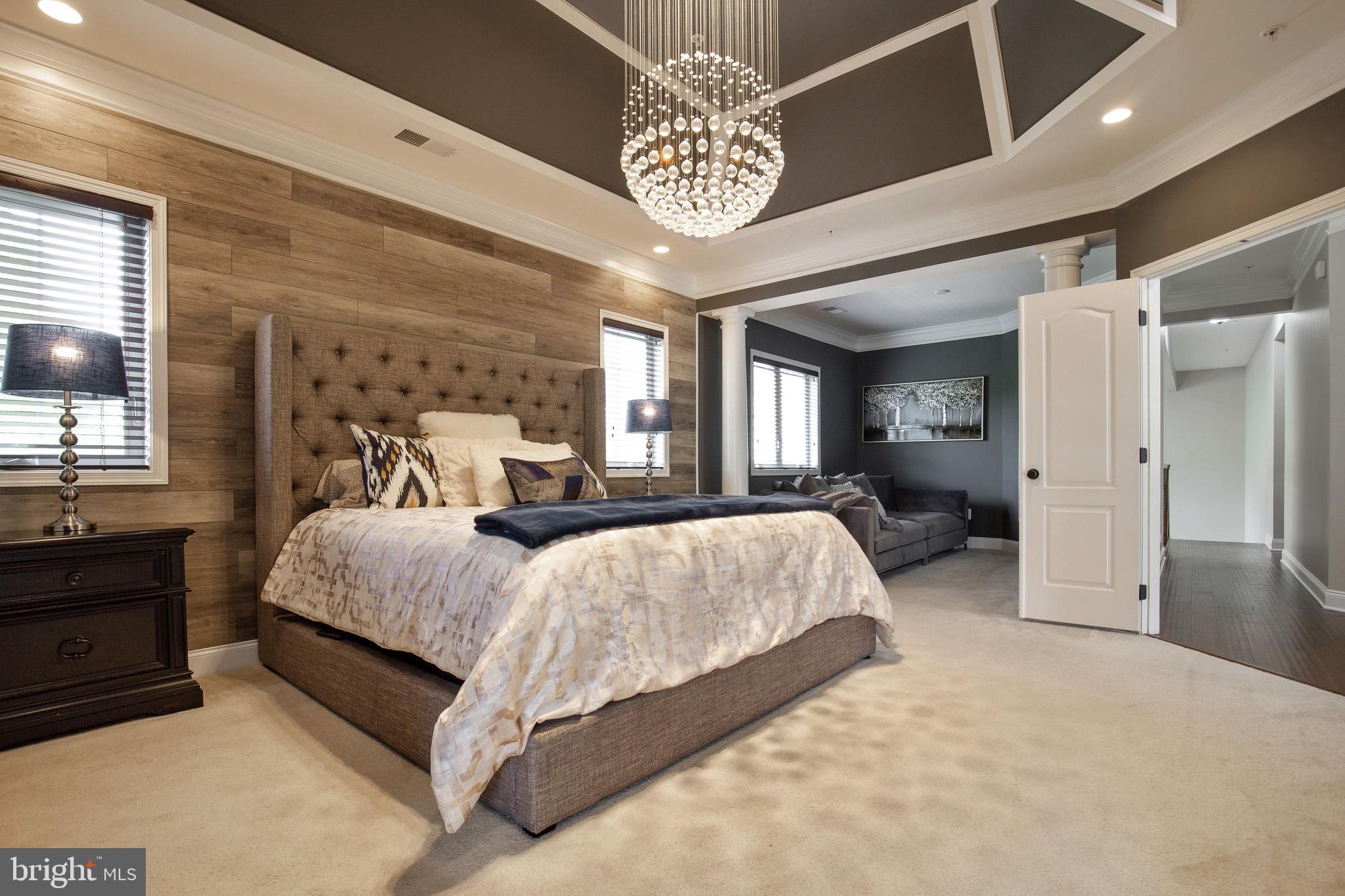 4201 Rolling Paddock Drive Upper Marlboro, MD 20772 - Photo 34 of 62 a spacious bedroom with a bed and a chandelier