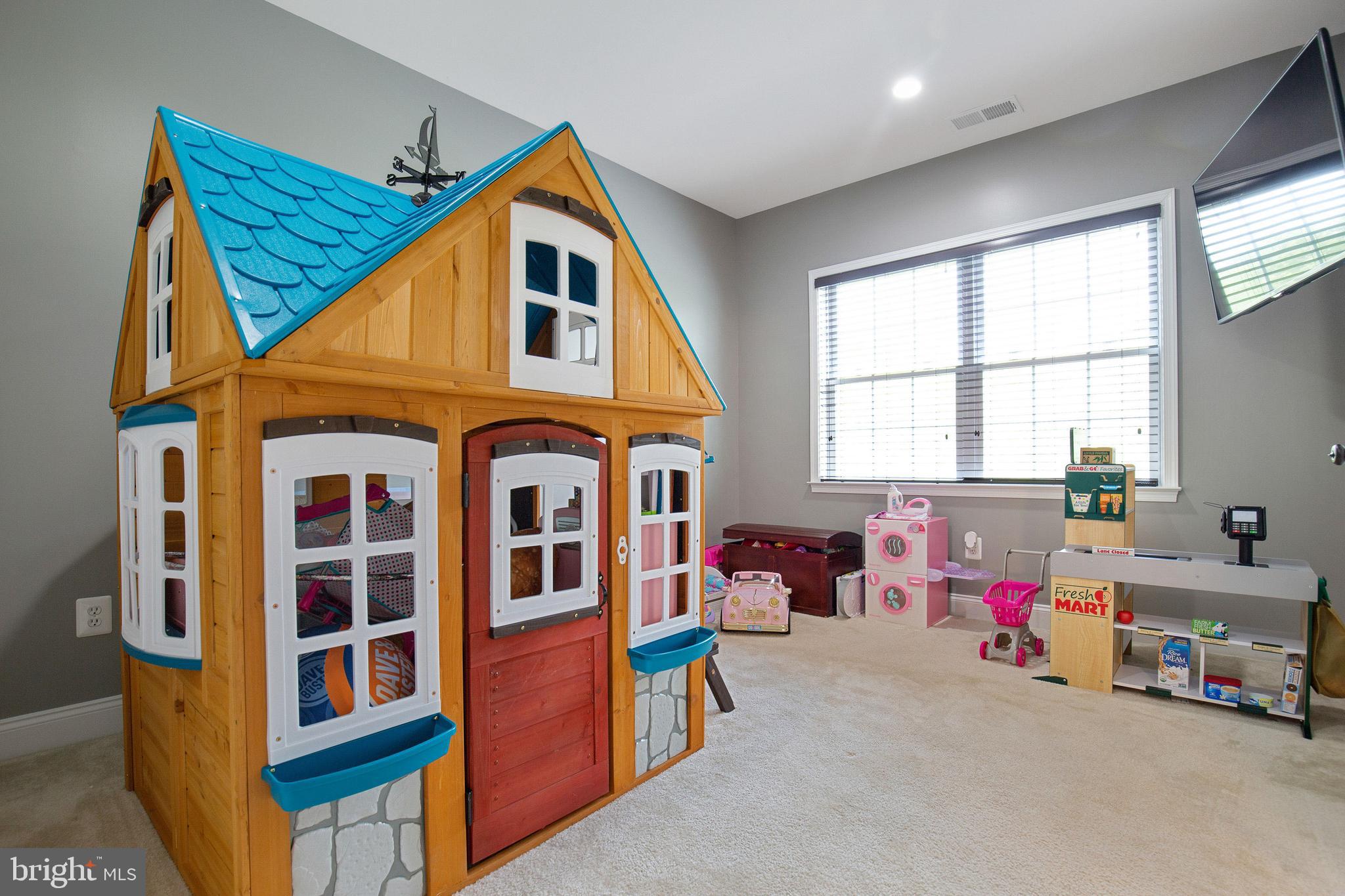 4201 Rolling Paddock Drive Upper Marlboro, MD 20772 - Photo 43 of 62 a view of living room with baby crib and a window
