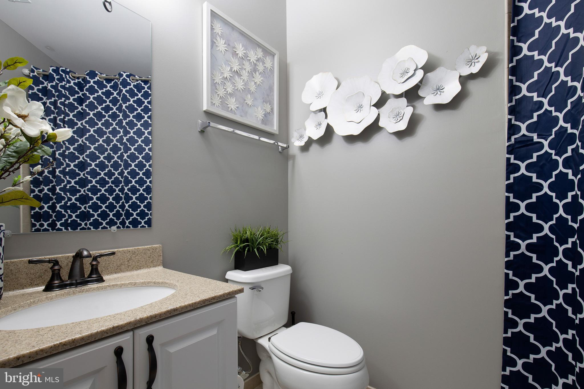 4201 Rolling Paddock Drive Upper Marlboro, MD 20772 - Photo 46 of 62 a bathroom with a sink mirror vanity and toilet