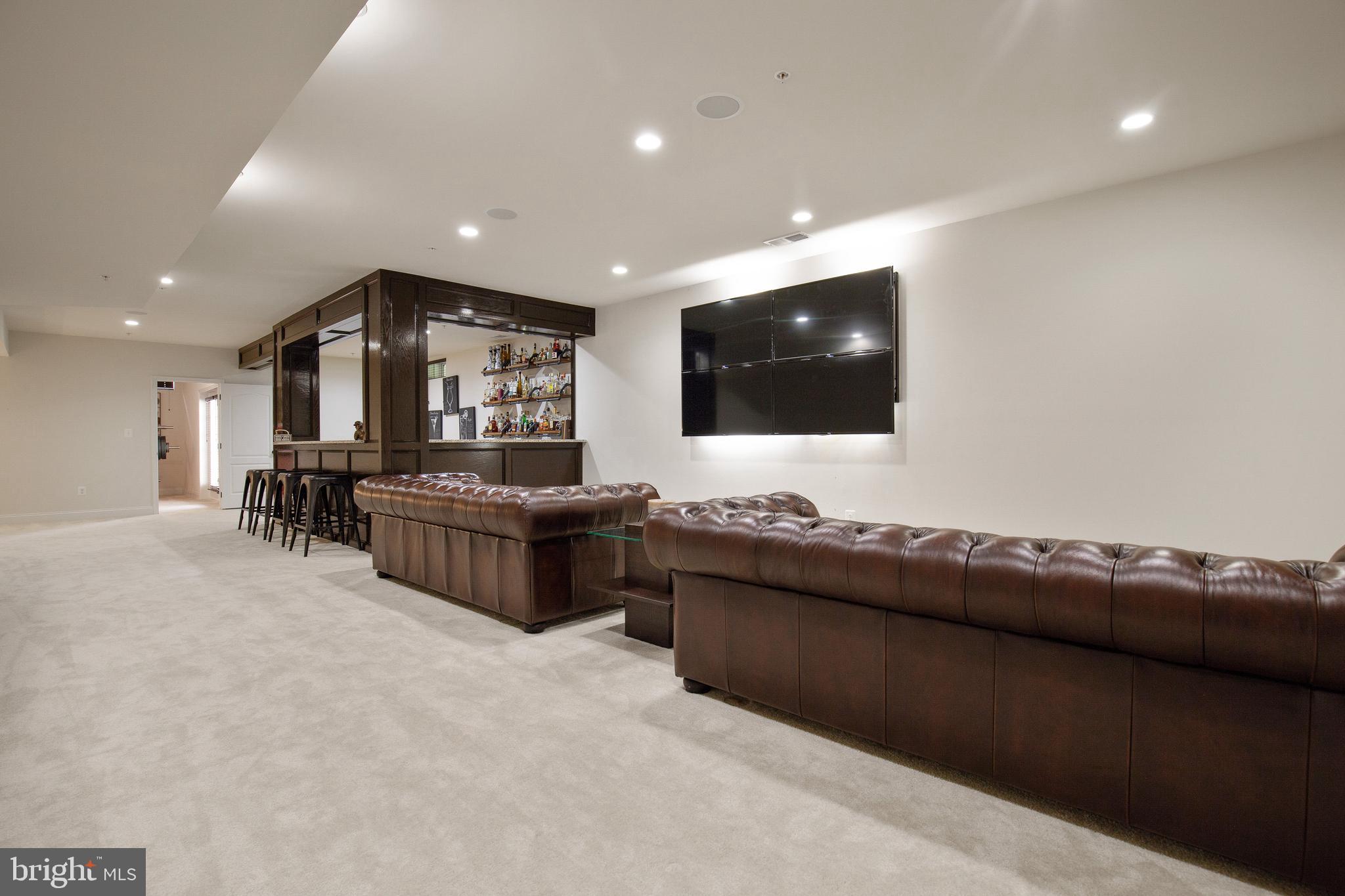 4201 Rolling Paddock Drive Upper Marlboro, MD 20772 - Photo 52 of 62 a living room with furniture and a flat screen tv