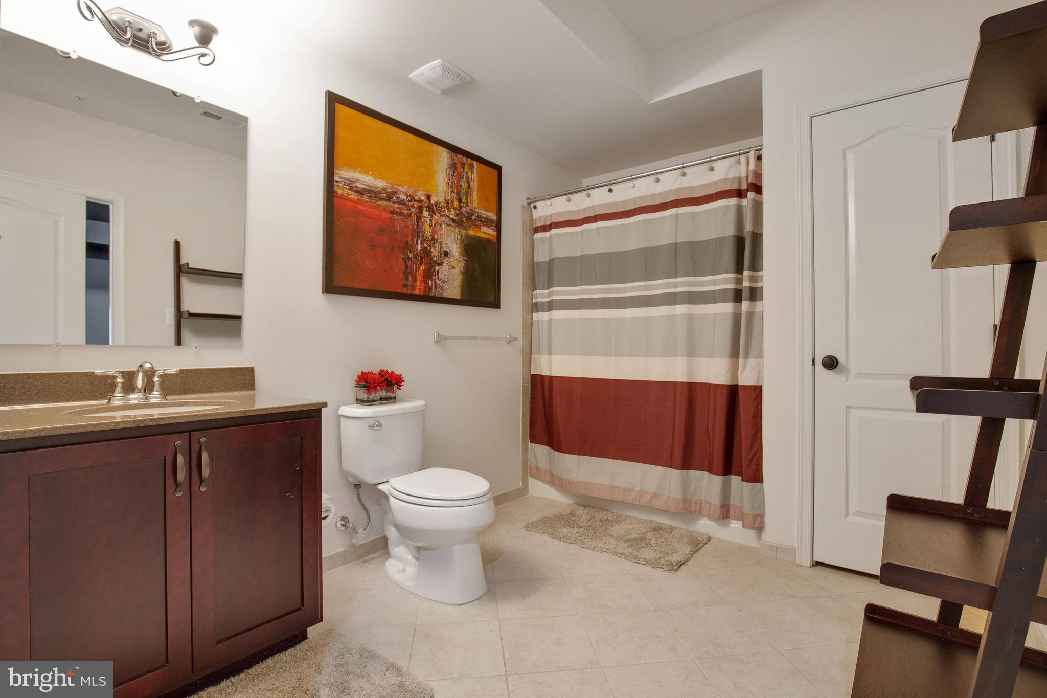 4201 Rolling Paddock Drive Upper Marlboro, MD 20772 - Photo 57 of 62 a bathroom with a sink a toilet and shower