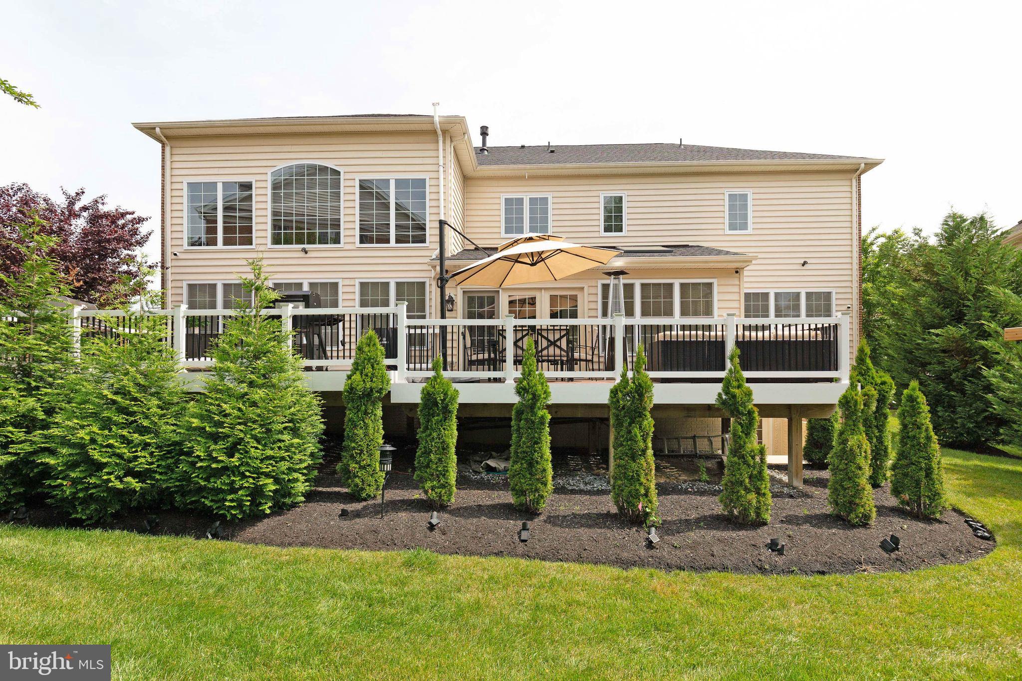 4201 Rolling Paddock Drive Upper Marlboro, MD 20772 - Photo 59 of 62 a front view of a house with a yard table and chairs