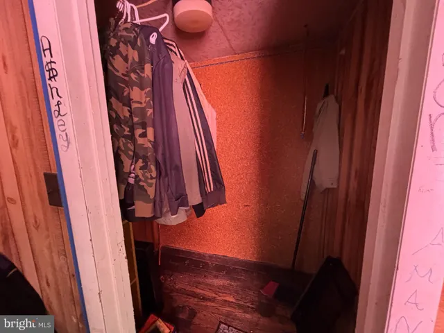 a view of a closet with wooden floor