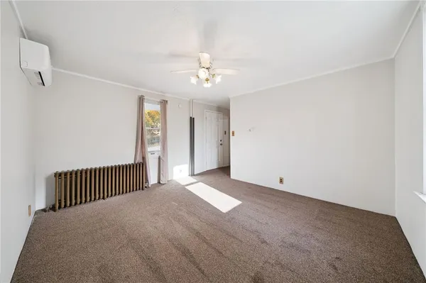a view of a livingroom with a ceiling fan and window