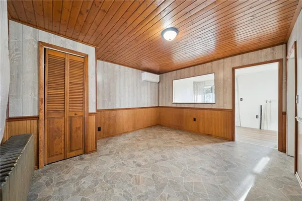 an empty room with closet area