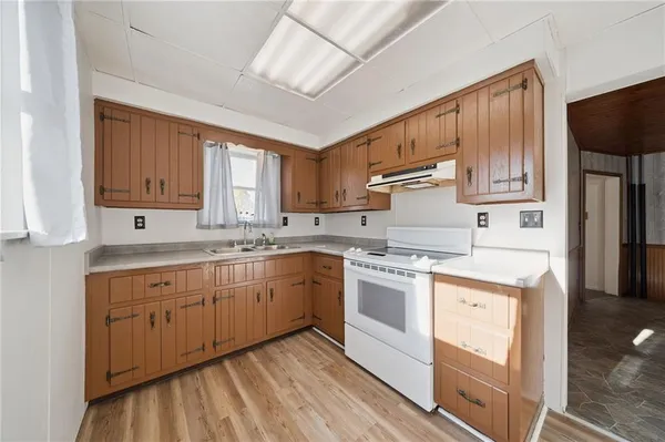 a kitchen with stainless steel appliances granite countertop a stove sink and cabinets