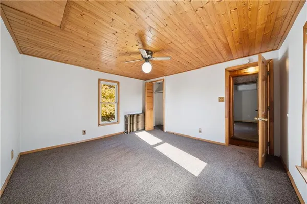 an empty room with windows and closet