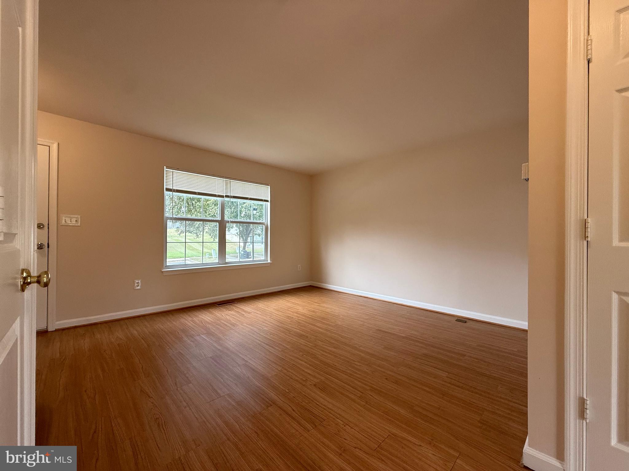 3511 Orchard Shade Road Randallstown, MD 21133 - Photo 12 of 30 an empty room with wooden floor and windows