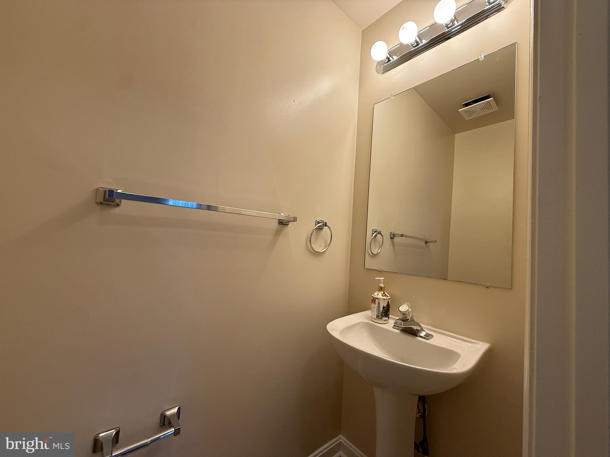 3511 Orchard Shade Road Randallstown, MD 21133 - Photo 13 of 30 a bathroom with a sink a mirror and a toilet