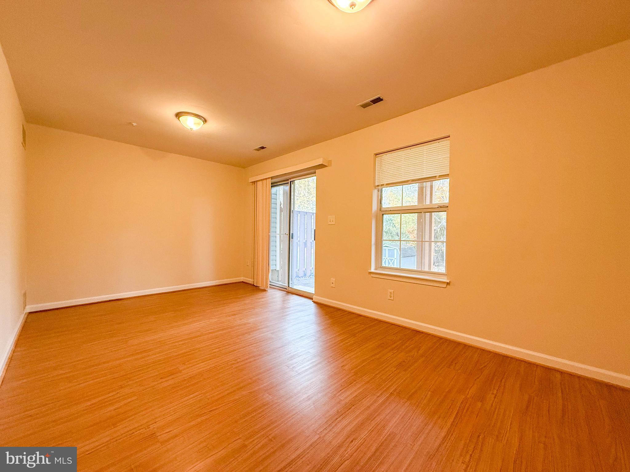 3511 Orchard Shade Road Randallstown, MD 21133 - Photo 15 of 27 a view of an empty room with wooden floor and a window