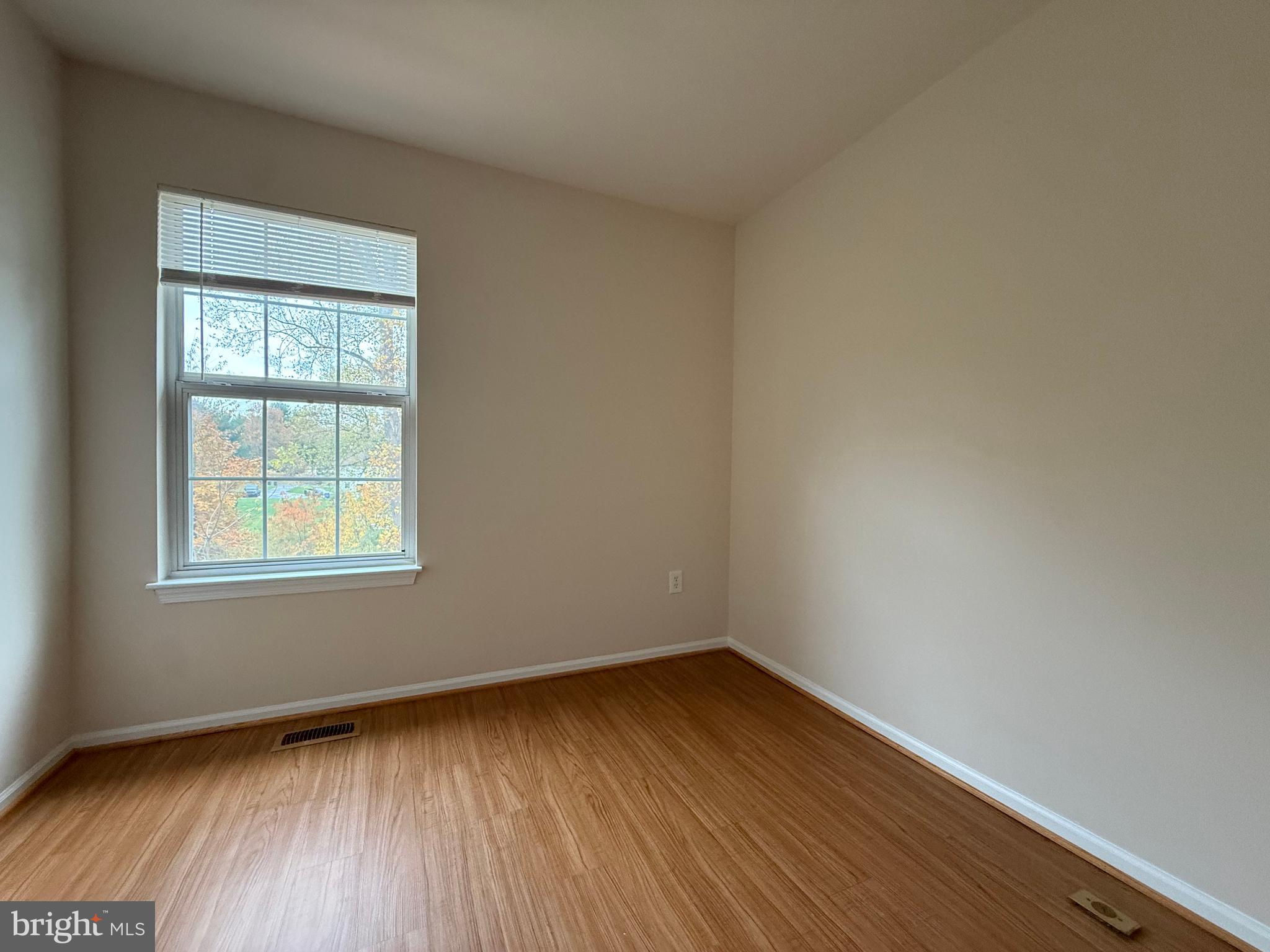 3511 Orchard Shade Road Randallstown, MD 21133 - Photo 19 of 30 a view of an empty room with wooden floor and a window