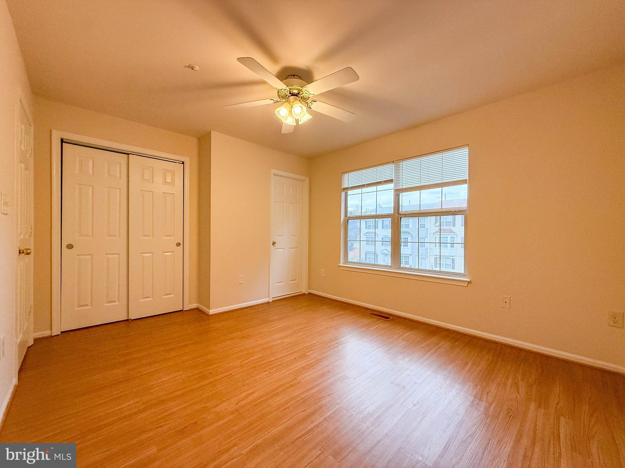 3511 Orchard Shade Road Randallstown, MD 21133 - Photo 19 of 27 a view of an empty room with wooden floor and a window