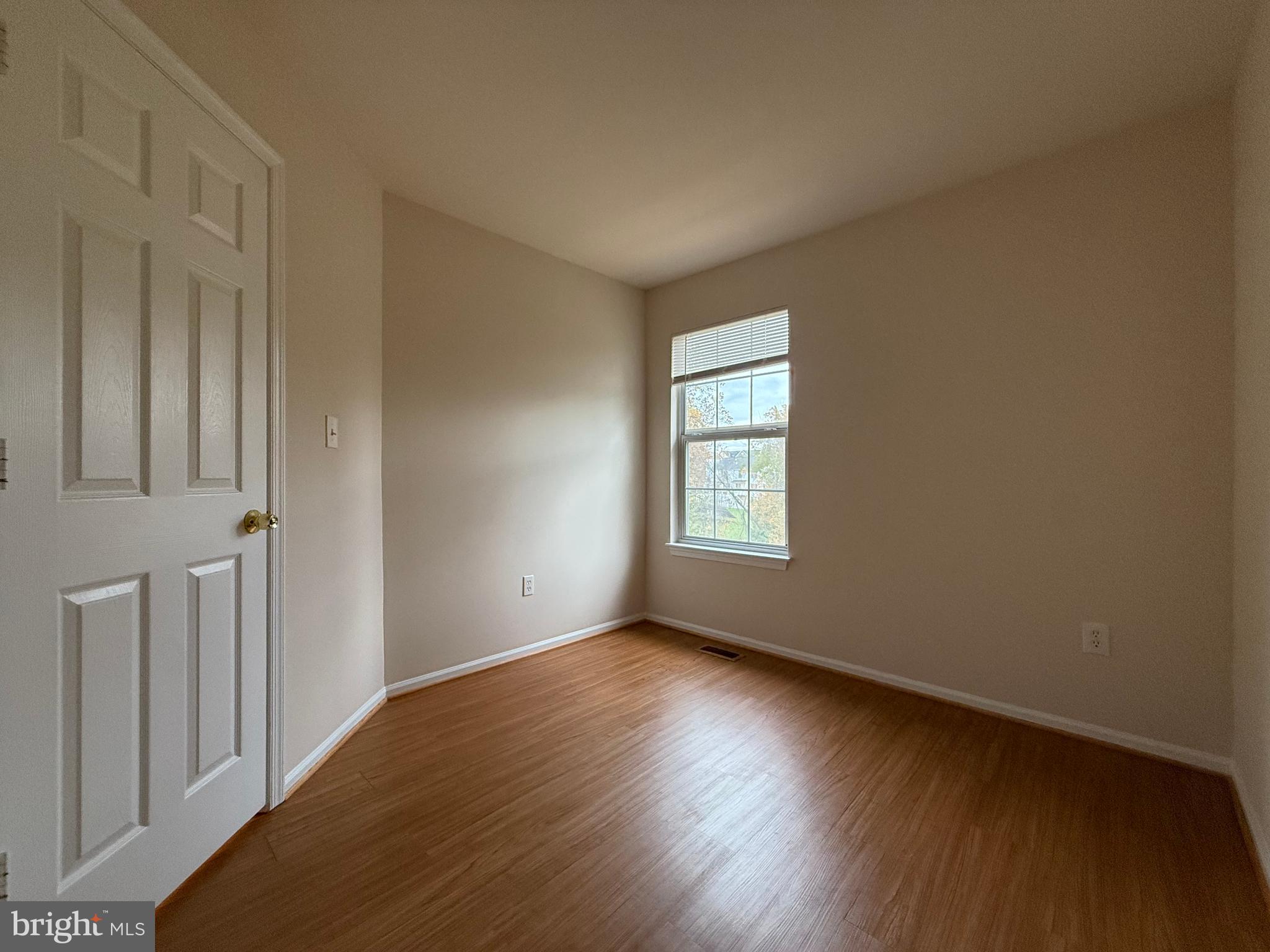 3511 Orchard Shade Road Randallstown, MD 21133 - Photo 20 of 30 a view of an empty room with wooden floor and a window