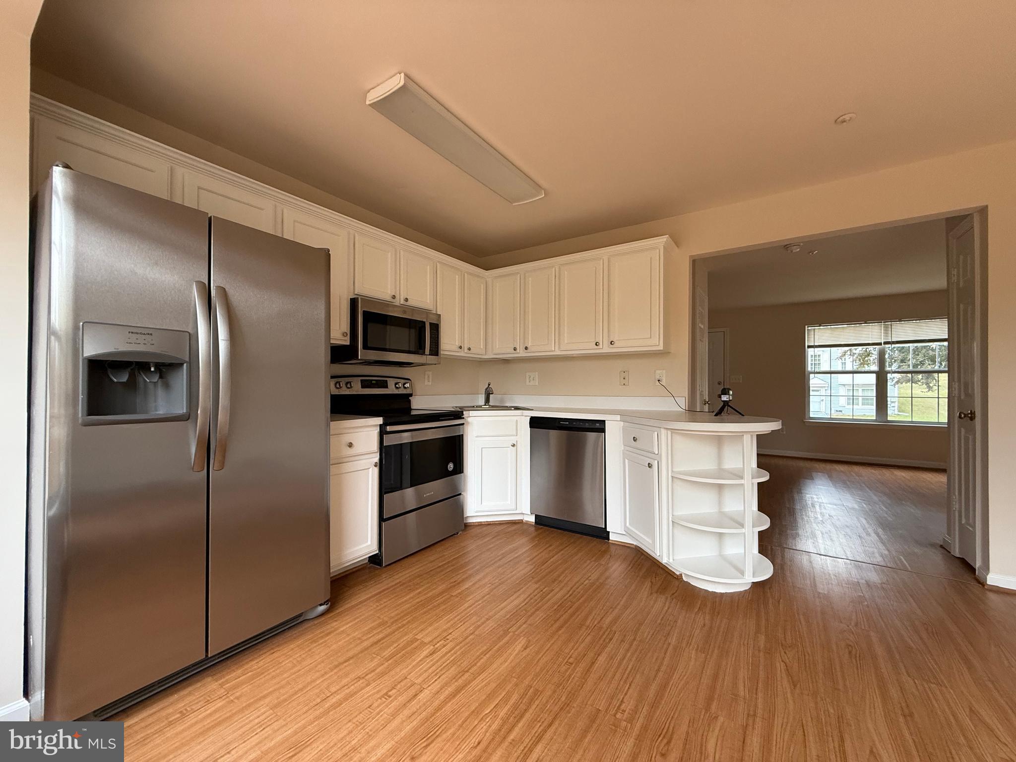 3511 Orchard Shade Road Randallstown, MD 21133 - Photo 2 of 30 a kitchen with a refrigerator and a stove top oven