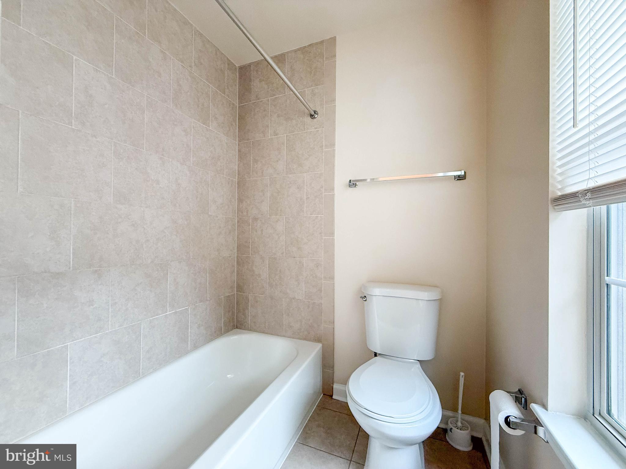 3511 Orchard Shade Road Randallstown, MD 21133 - Photo 22 of 27 a white toilet sitting next to a bath tub and a shower