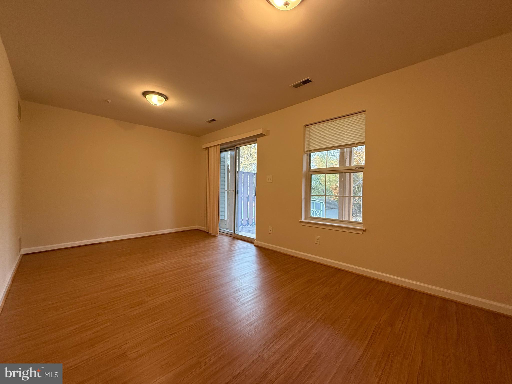 3511 Orchard Shade Road Randallstown, MD 21133 - Photo 26 of 30 a view of an empty room with wooden floor and a window