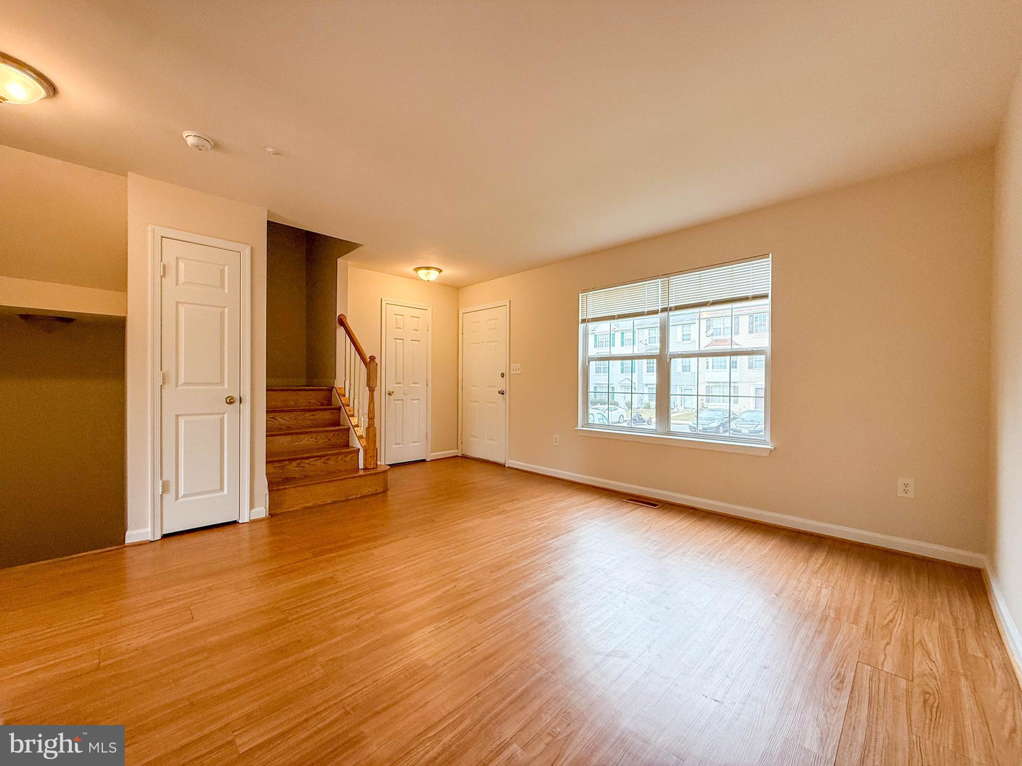 3511 Orchard Shade Road Randallstown, MD 21133 - Photo 4 of 27 a view of an empty room with wooden floor and a window
