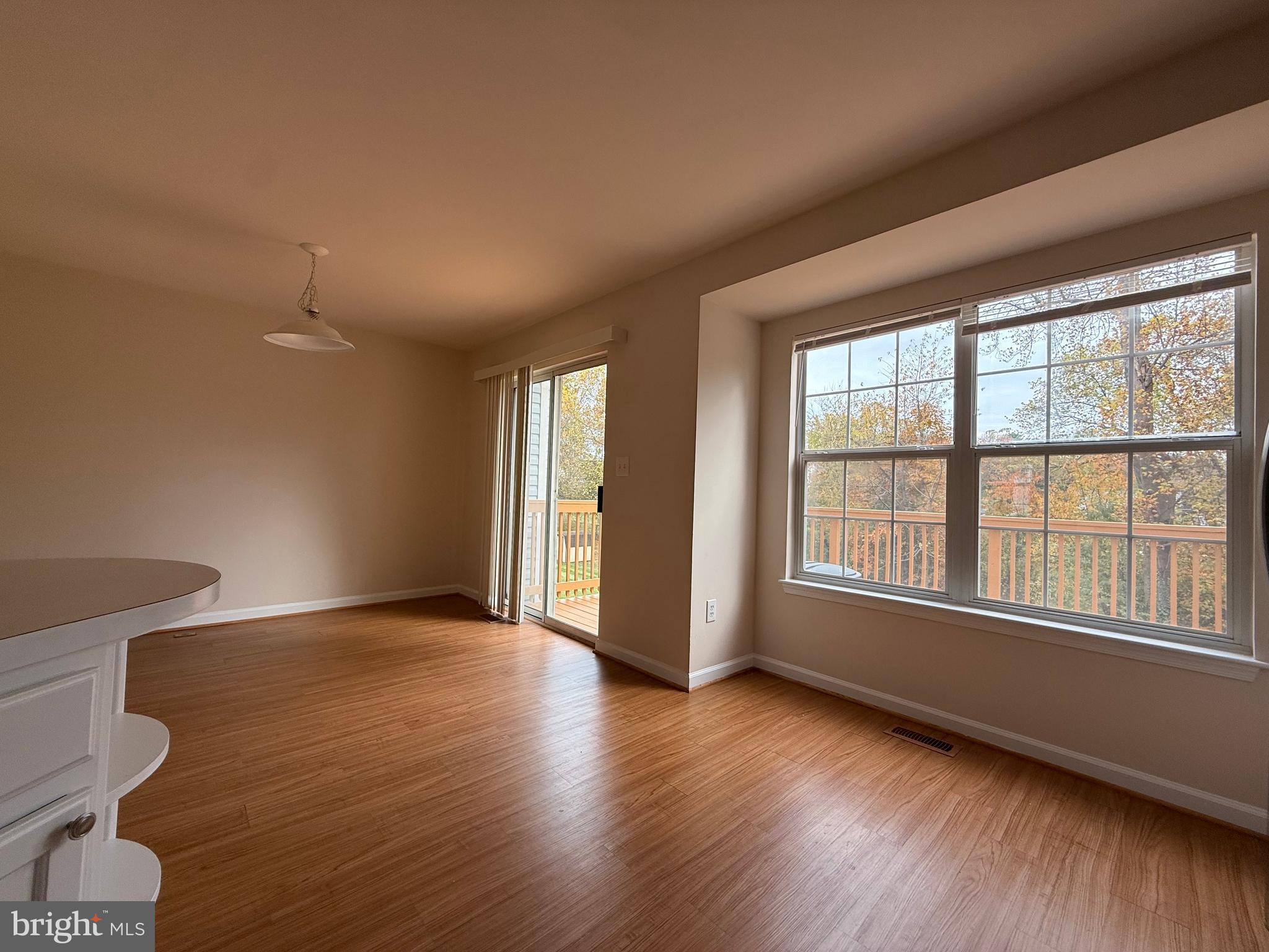 3511 Orchard Shade Road Randallstown, MD 21133 - Photo 4 of 30 an empty room with wooden floor and windows