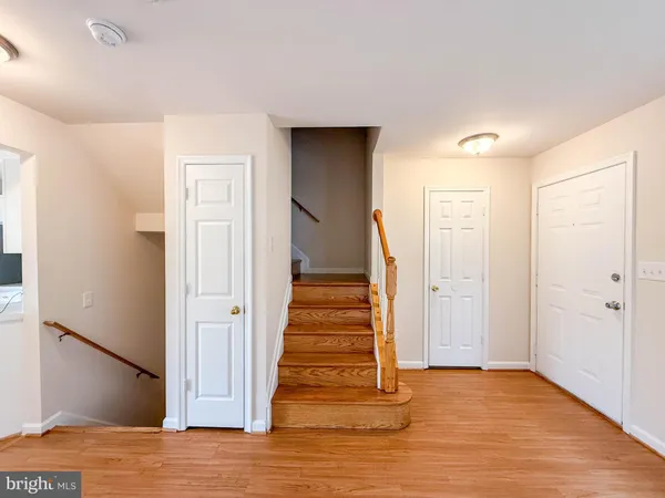 a view of a hallway with wooden floor and entryway