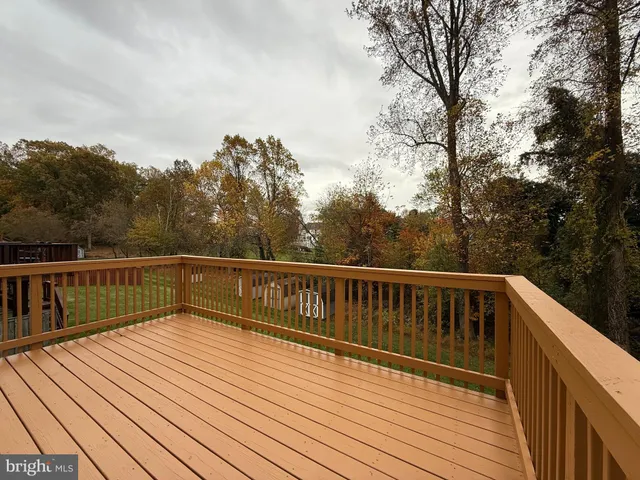 a view of balcony with wooden floor and fence