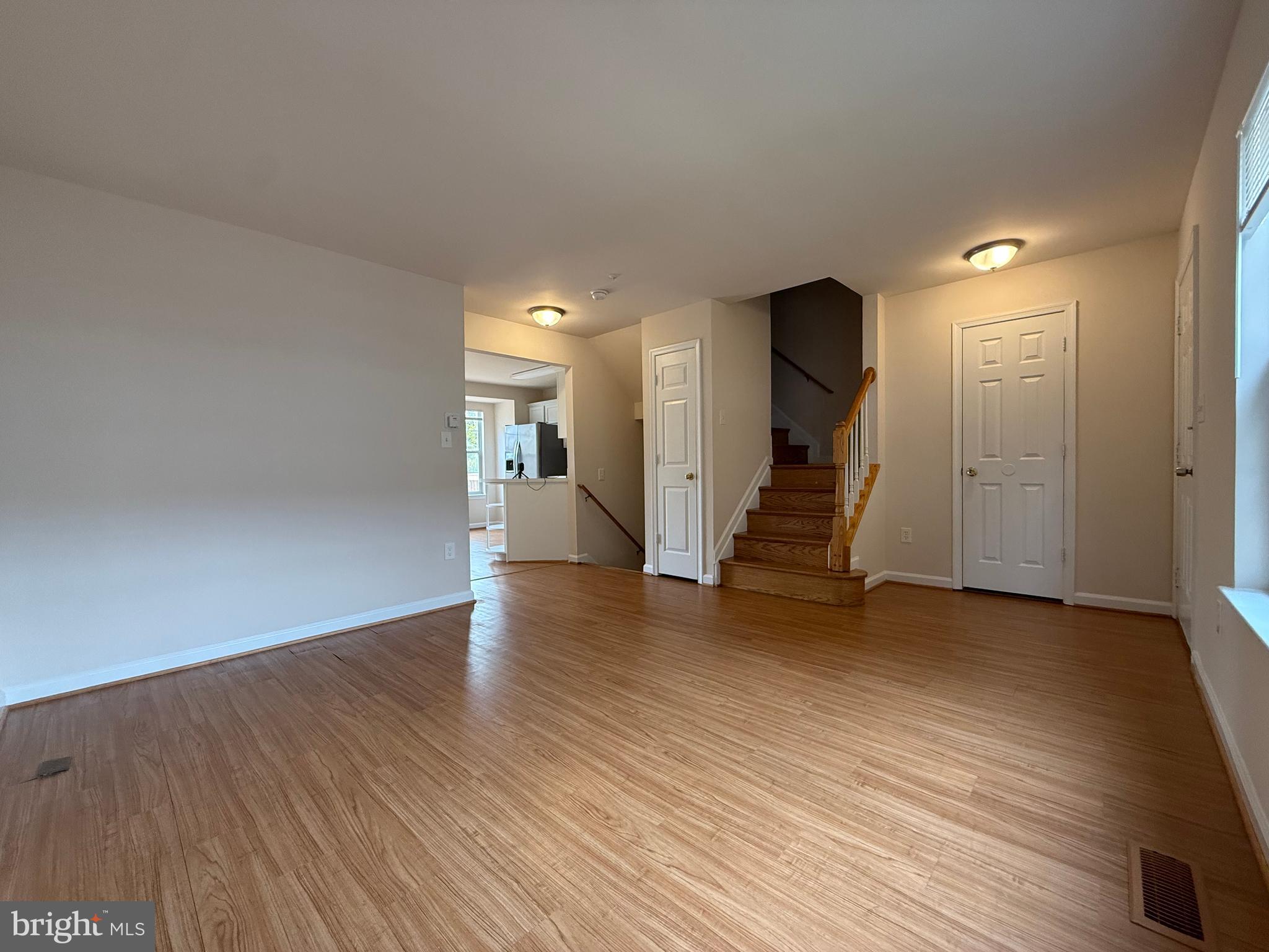 3511 Orchard Shade Road Randallstown, MD 21133 - Photo 9 of 30 a view of a hallway with wooden floor and stairs