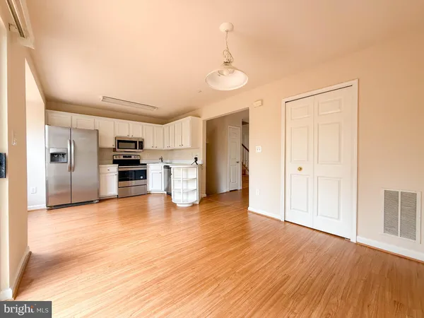 a view of a kitchen with a sink and a refrigerator