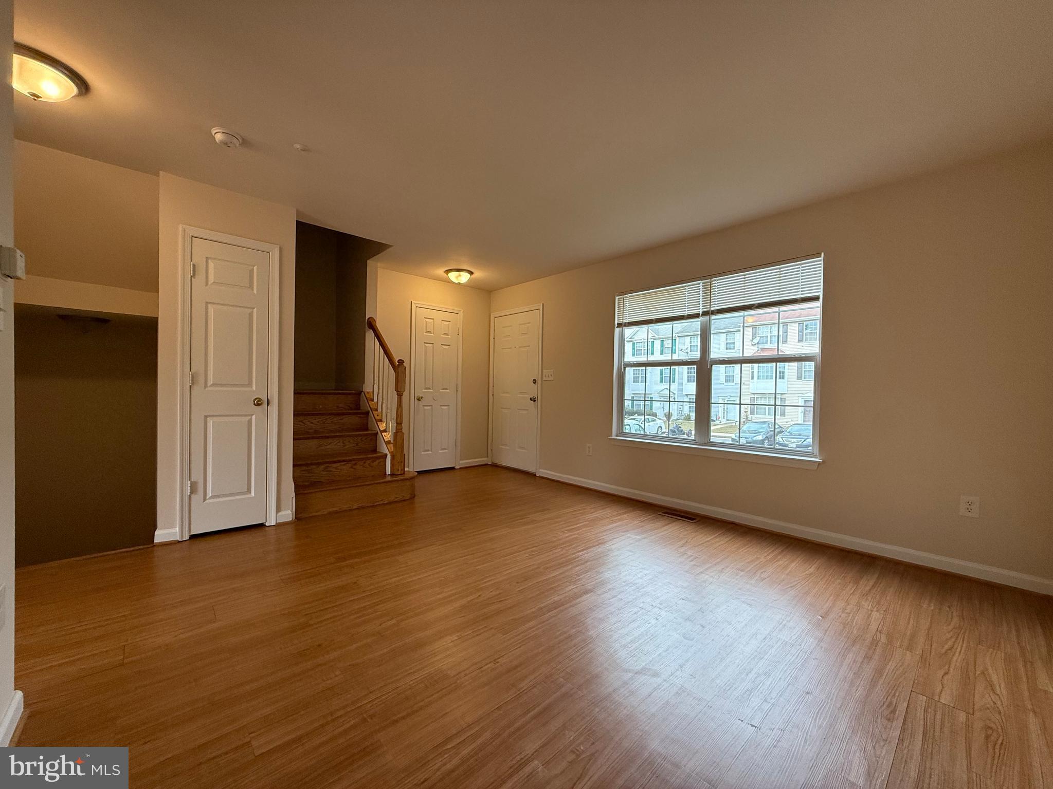 3511 Orchard Shade Road Randallstown, MD 21133 - Photo 10 of 30 an empty room with wooden floor and windows